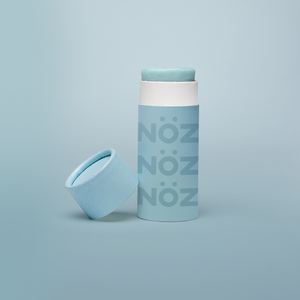 A stick of Noz’s reef-safe sunscreen in teal with the cap off