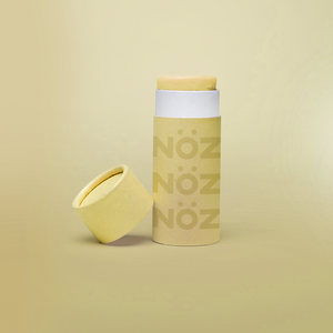 A stick of Noz’s reef-safe sunscreen in yellow with the cap off